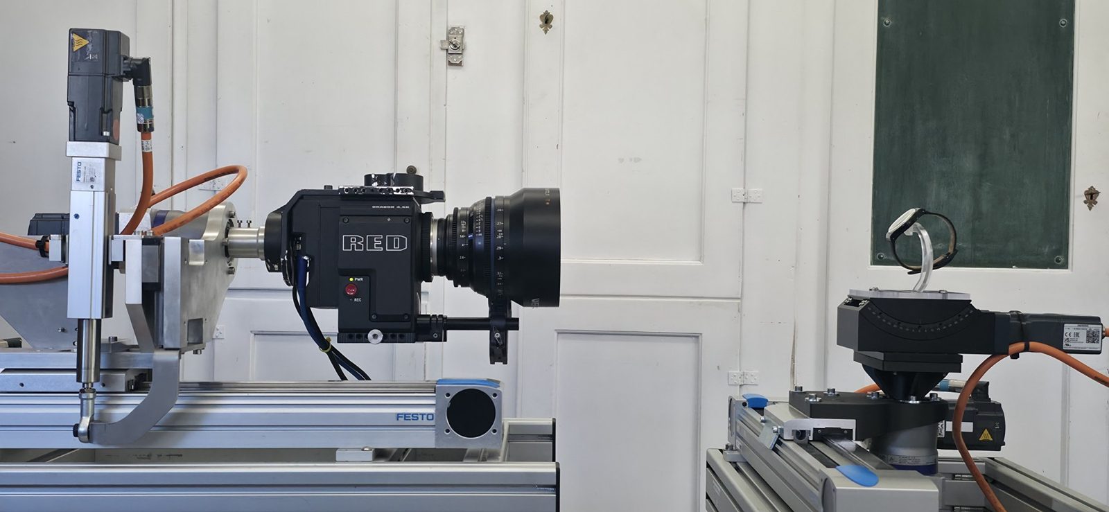 KINETIX Motion-Control-System in der Werkstatt Thun: RED-Kamera mit Zeiss CP.2 gegenüber einer Armbanduhr auf Turntable und Neigeachse
